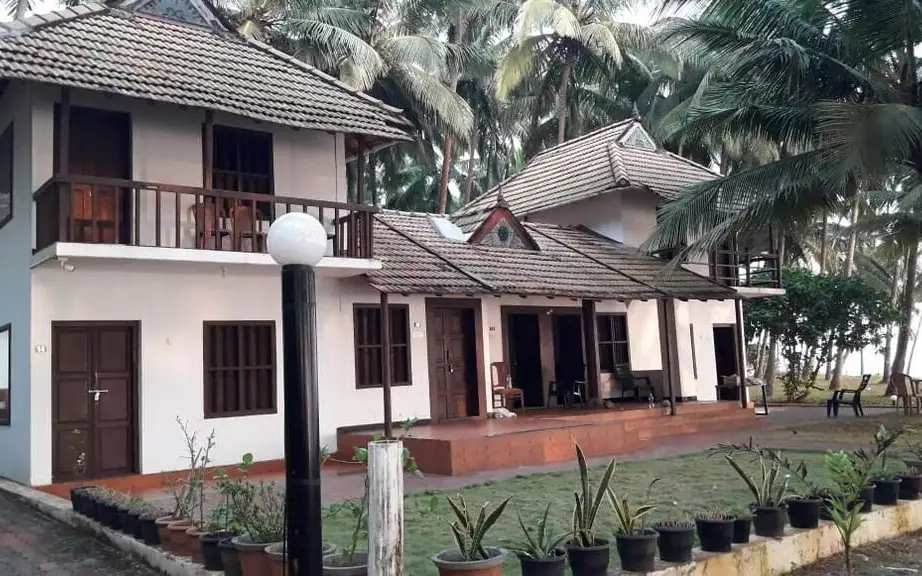 Kanbay Beach Resort cottages at Thottada; the property houses its rooftop restaurant. This photograph shows the property exterior, not the dining area.