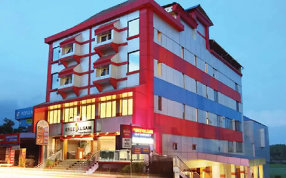 The red-and-white Sreevalsam Residency building in Kulanada, pictured in its Kerala Tourism listing.