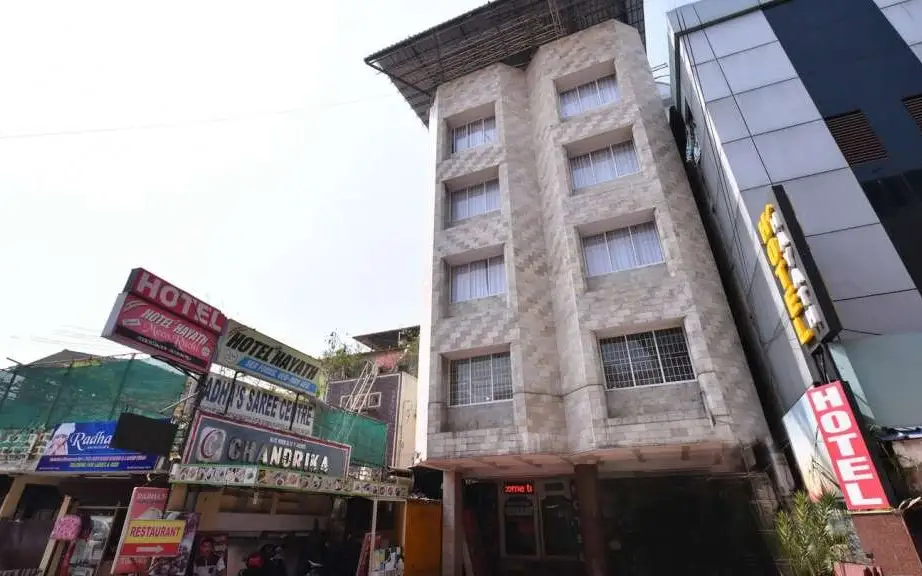 Street exterior in Chandrika Residency’s Kerala Tourism listing; neighbouring hotel signs also appear. Confirm its current appearance and visitor entrance.