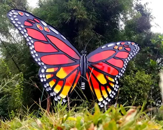 A large decorative butterfly installation among Chellarkovil’s planted garden beds.