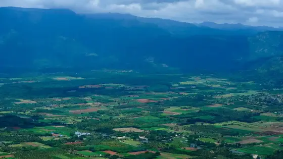 Cultivated plains, settlements and distant hills seen from the Chellarkovil landscape.