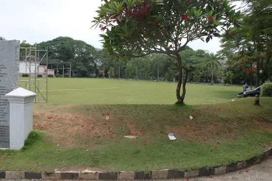 The open maidan of the Durbar Hall Ground in Ernakulam, with a marked pitch and an inscribed stone at the edge