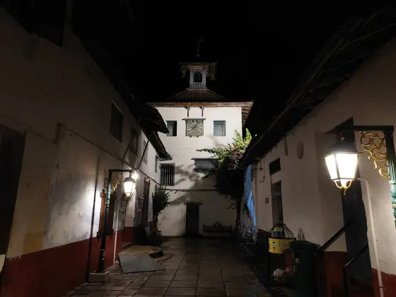 The Paradesi Synagogue clock tower and street after dark.