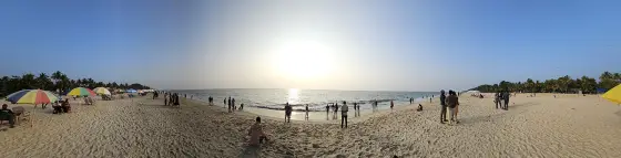 Marari Beach at sunset on 11 February 2024 — umbrellas, chairs and several hundred people along the waterline. EXIF-dated.
