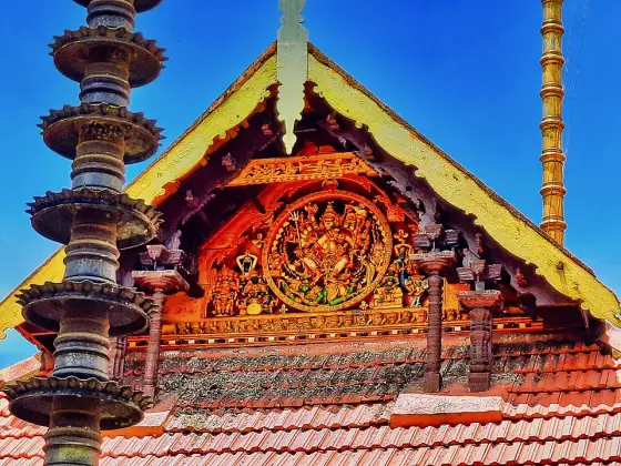 Carved figures on a temple gable at Haripad.