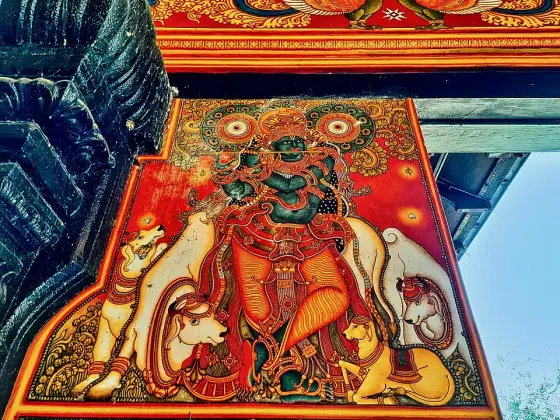 A painted figure among the temple decorations.