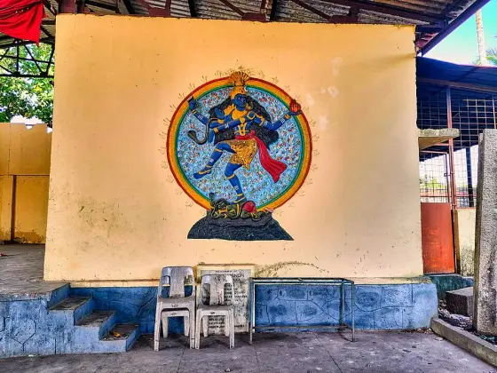 A painted Shiva figure on a temple wall.