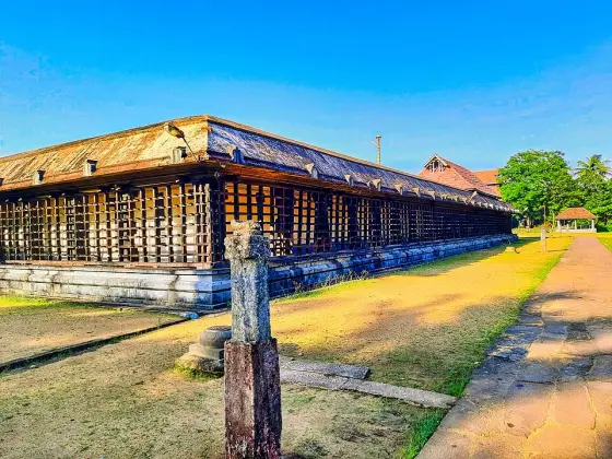 Rows of lamps along the outer temple wall.