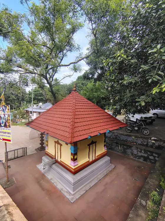 A small tiled-roof shrine in the Achankovil compound.