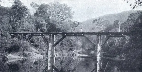 A stone-and-timber bridge on the former Cochin State Forest Tramway, published in 1910. This is a historical view along the forest line, not the modern railway station.