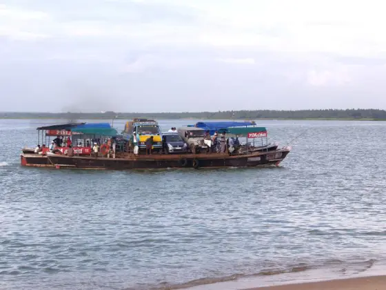 The crossing at the river mouth — a few minutes of water in place of half an hour of road.