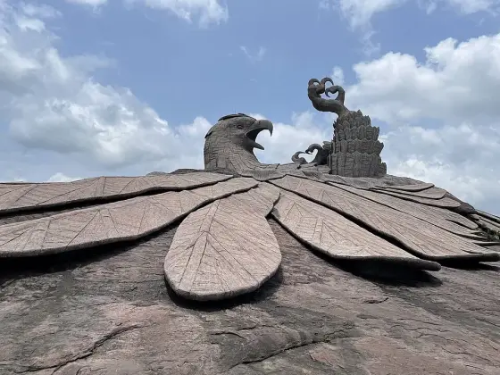 The sculpted surface of Jatayu against the rocky hill.