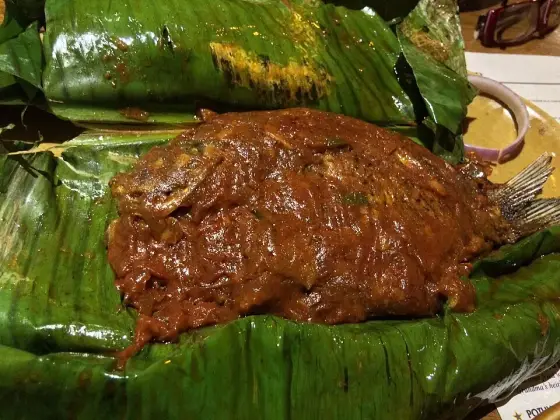 Karimeen pollichathu — pearl spot, masala, banana leaf, and not much else.