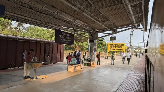 Passengers on a platform at Koyilandy railway station.