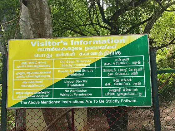 A photographed visitor information board at the Kumbhavurutty entrance; the listed charges are historical.