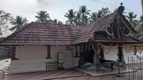 The tiled-roof Shiva shrine within the Lokanarkavu complex.