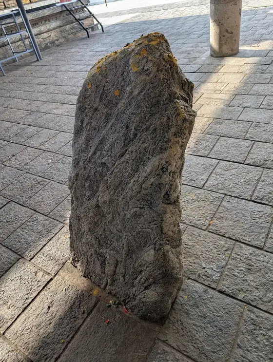 A carved stone standing in the courtyard.