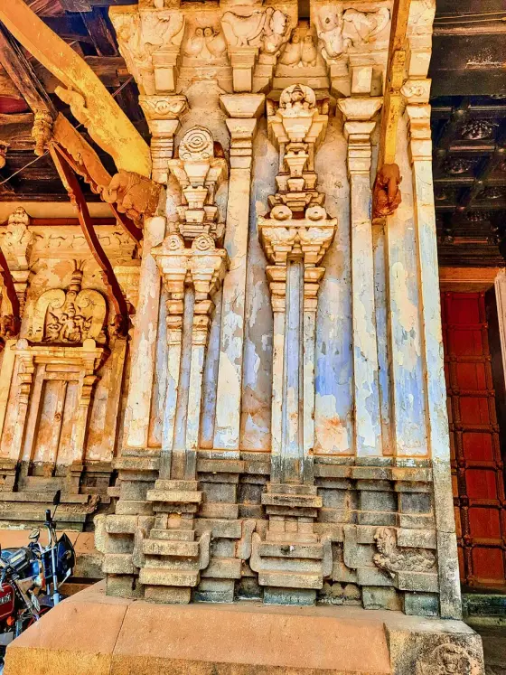 Carved figures and columns on the temple’s outer wall.