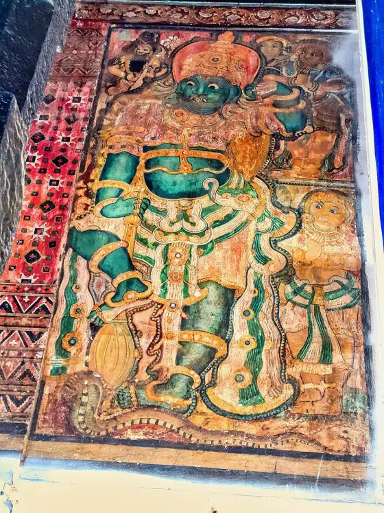 A painted figure on a wall panel at Ettumanoor Mahadeva Temple.