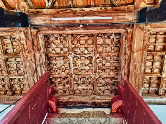 Carved wooden panels overhead at Ettumanoor.