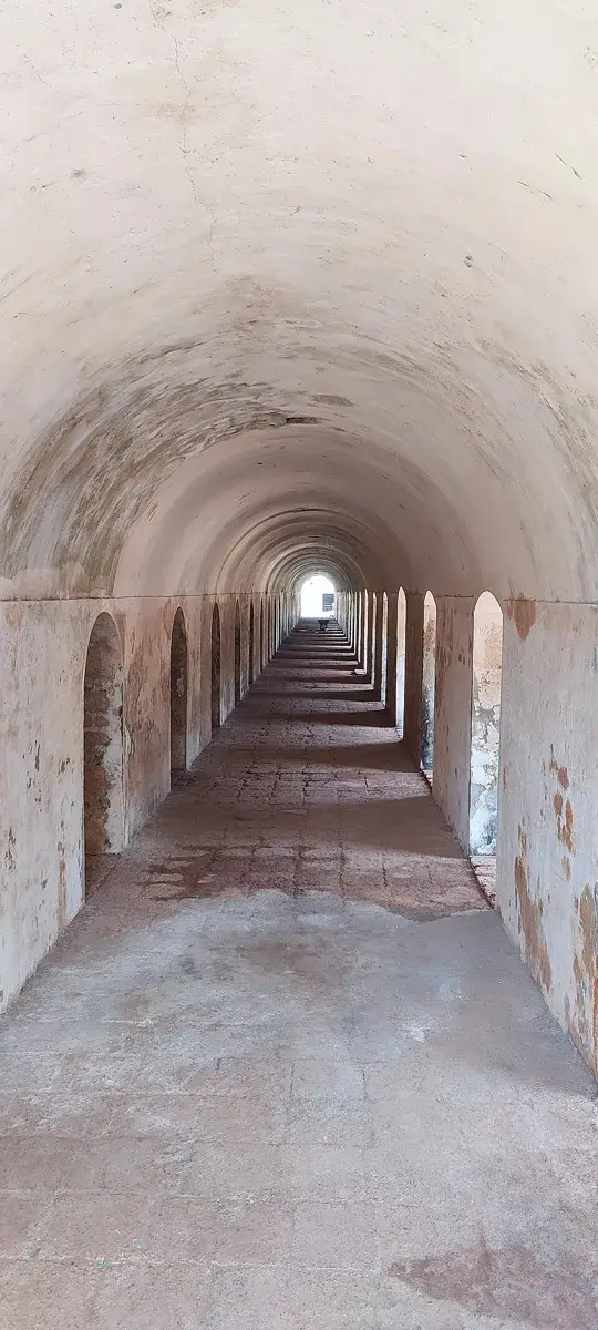 An arched passage identified by the photographer as the fort’s former horse stable.