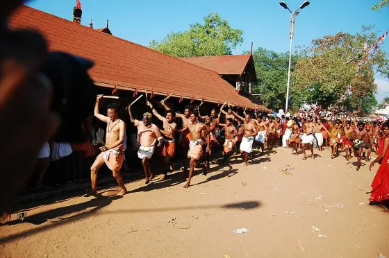 A historical photograph of the Kaavu theendal festival at Kodungallur.