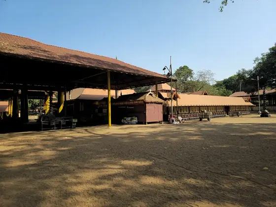 An open-sided timber-roofed hall in the temple compound.