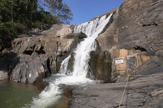 Water descending over dark rock at Kanthanpara.