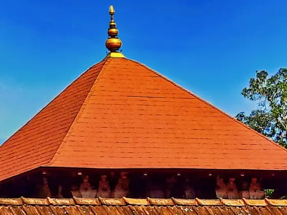 Roof tiles and finial above the circular shrine.