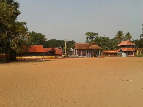 The broad sandy courtyard and surrounding temple buildings.