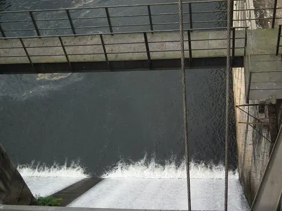 Water flowing below the dam structure.