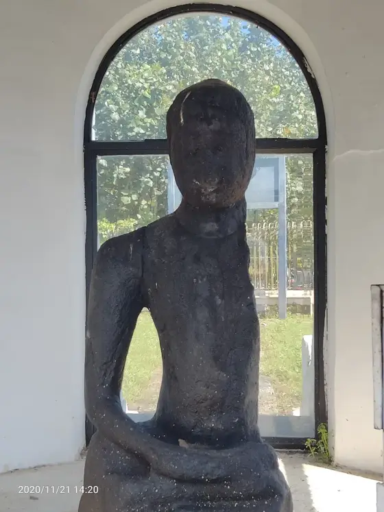 The surviving seated Buddha inside the shelter.