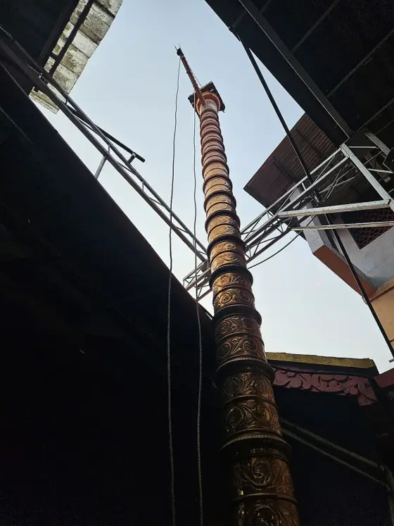 The tall flagstaff beneath the covered roof.