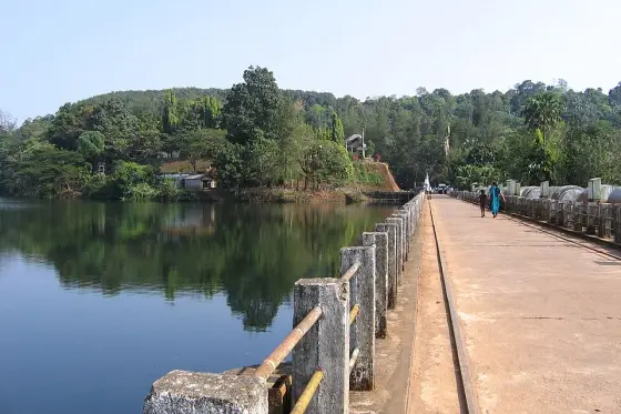The railed walkway beside the water.