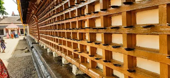 Rows of lamp holders on the temple wall.