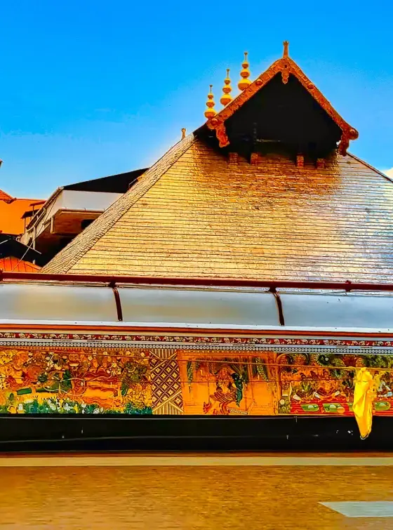 Painted wall panels below the sloping temple roof.