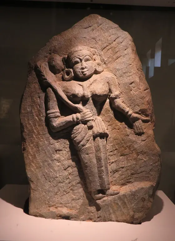 A relief figure on a reddish stone slab.
