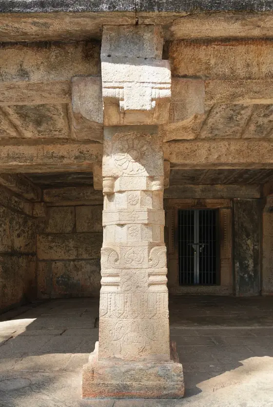 Carved faces of a granite pillar at Bathery Jain Temple.