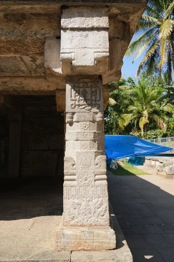 Carved pillar beneath the stone roof at Bathery Jain Temple.