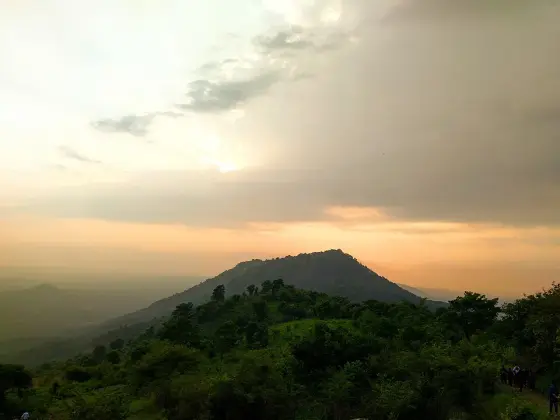 The hill silhouette beneath the evening sky.