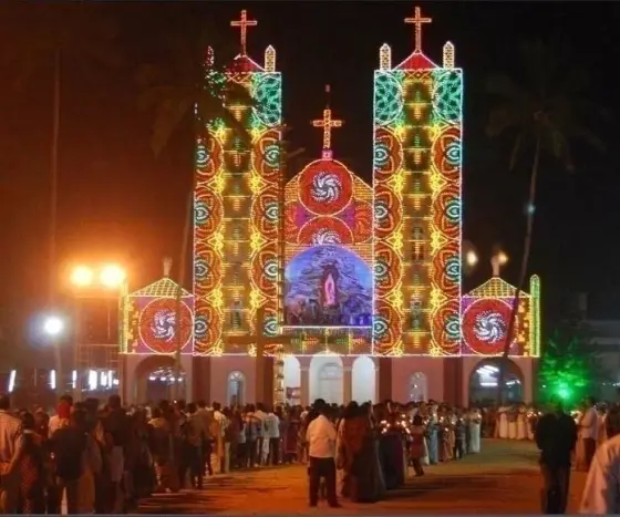 Pallikkunnu Church’s facade illuminated at night in the festival archive.