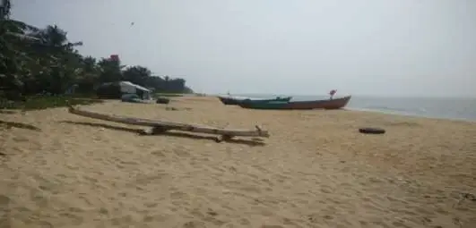 Boats rest on the Hosdurg fishing shore in the state coastal-tourism study; this photograph records the wider Kanhangad coastal setting.