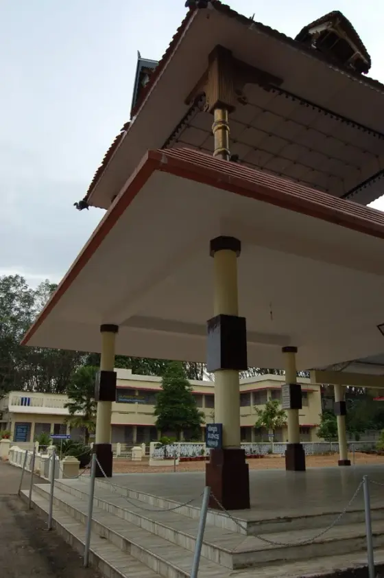 A tiled open pavilion with columns and flanking ramps in the neighbouring pilgrimage grounds.