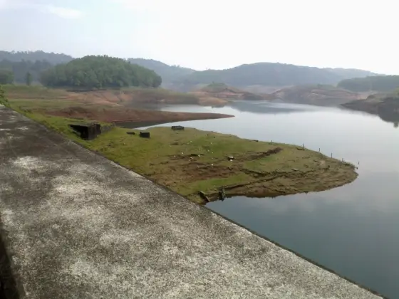 An exposed reservoir promontory seen beyond the roadside edge in an older photograph.