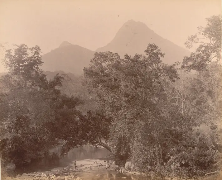 A sepia albumen photograph from the 1900s showing the Kallar river between forested banks with a peak rising behind