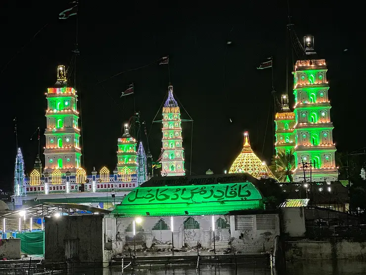 The five illuminated minarets of Nagore Dargah rising against the night sky during the festival