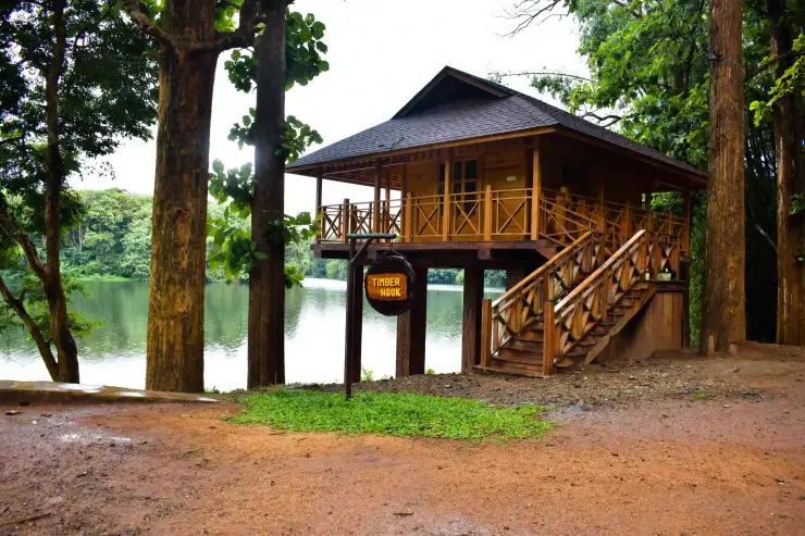 The named Timber Nook raised wooden cabin beside the reservoir in Parambikulam