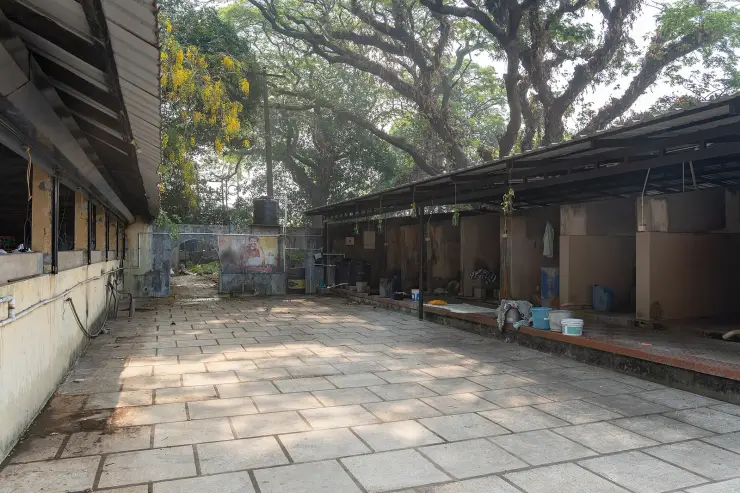 Two facing rows of open washing pens under corrugated roofs at the Dhobi Khana, Fort Kochi