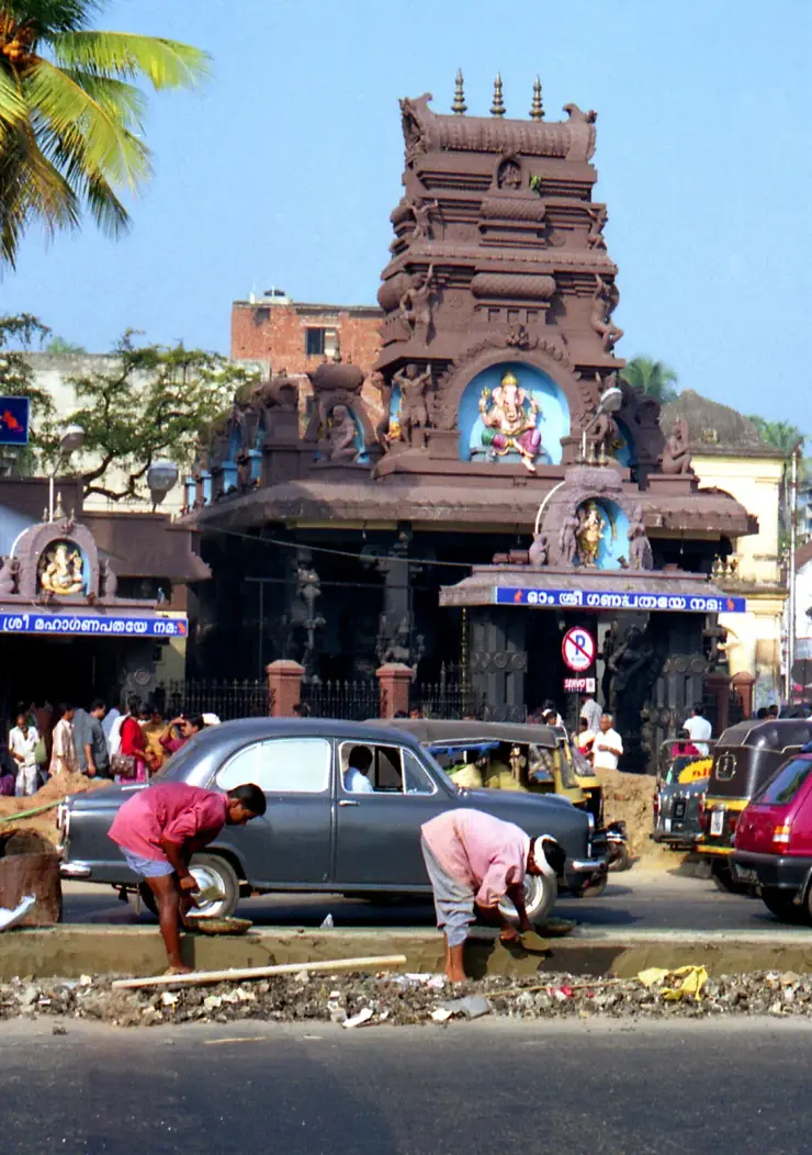 The street frontage of the Pazhavangadi Maha Ganapathy Temple at East Fort, Thiruvananthapuram, with its sculpted gopuram and Ganesha niche above the entrance