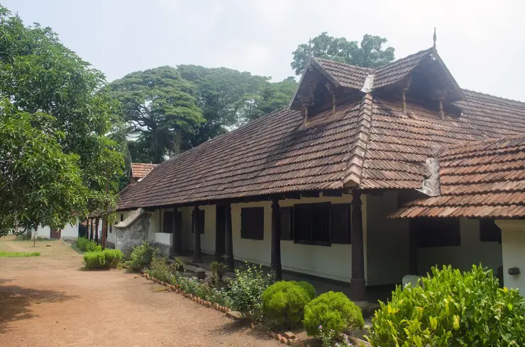 A pillared veranda and tiled roof of the main building at Hill Palace Museum, Tripunithura